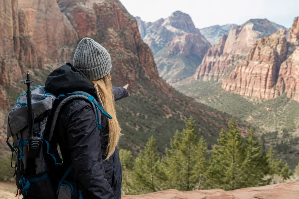 Traveler with a backpack exploring the scenic canyon views of Zion National Park during a peaceful private guided tour