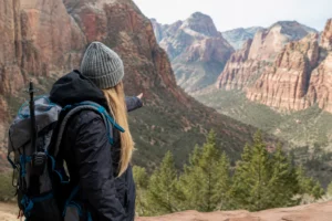 Traveler with a backpack exploring the scenic canyon views of Zion National Park during a peaceful private guided tour