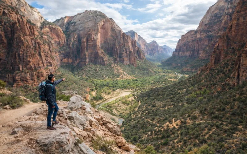 Hiker overlooking Zion National Park canyon landscape while exploring budget-friendly canyoneering routes